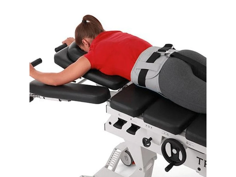 A patient positioned on the motorized spinal decompression table used at Carlisle Spine And Wellness